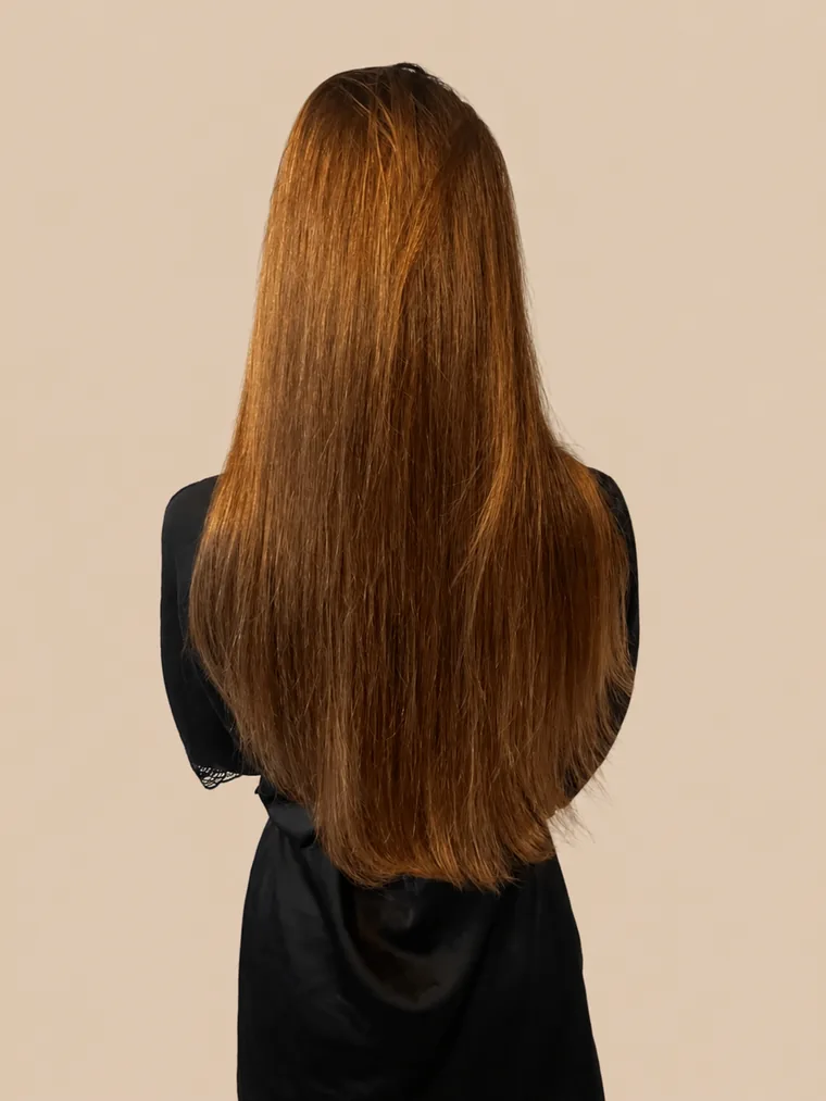 long, straight chestnut-brown hair, thinning towards the ends